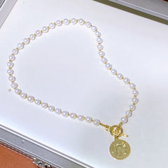 Natural pearl necklace with gold coin pendant